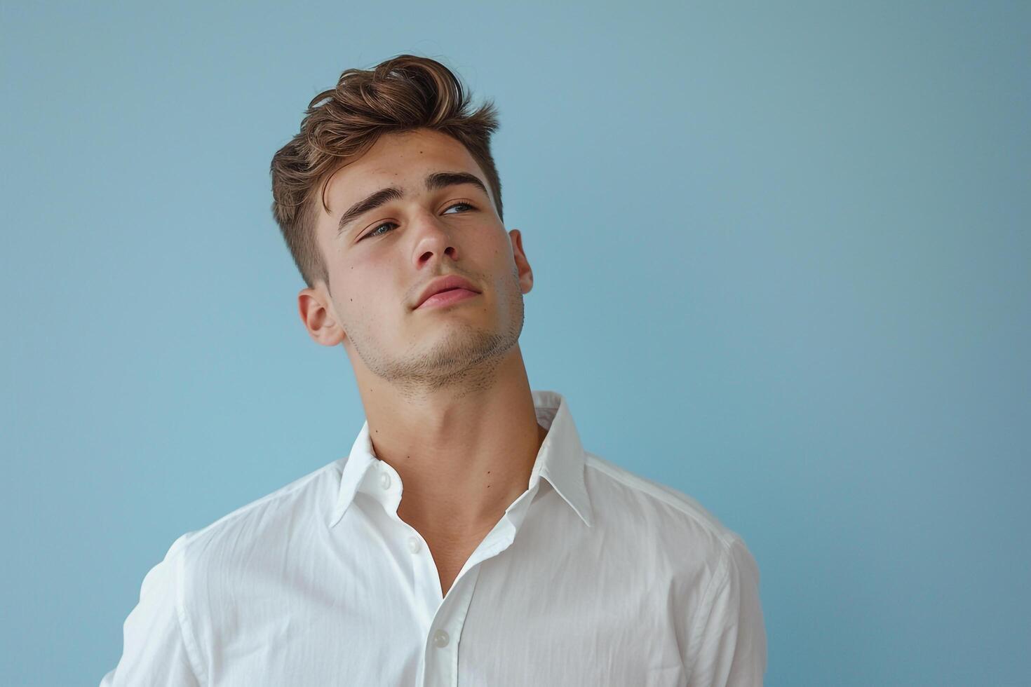 Stylish male fashion model in light blue casual button down relaxed modern portrait photo