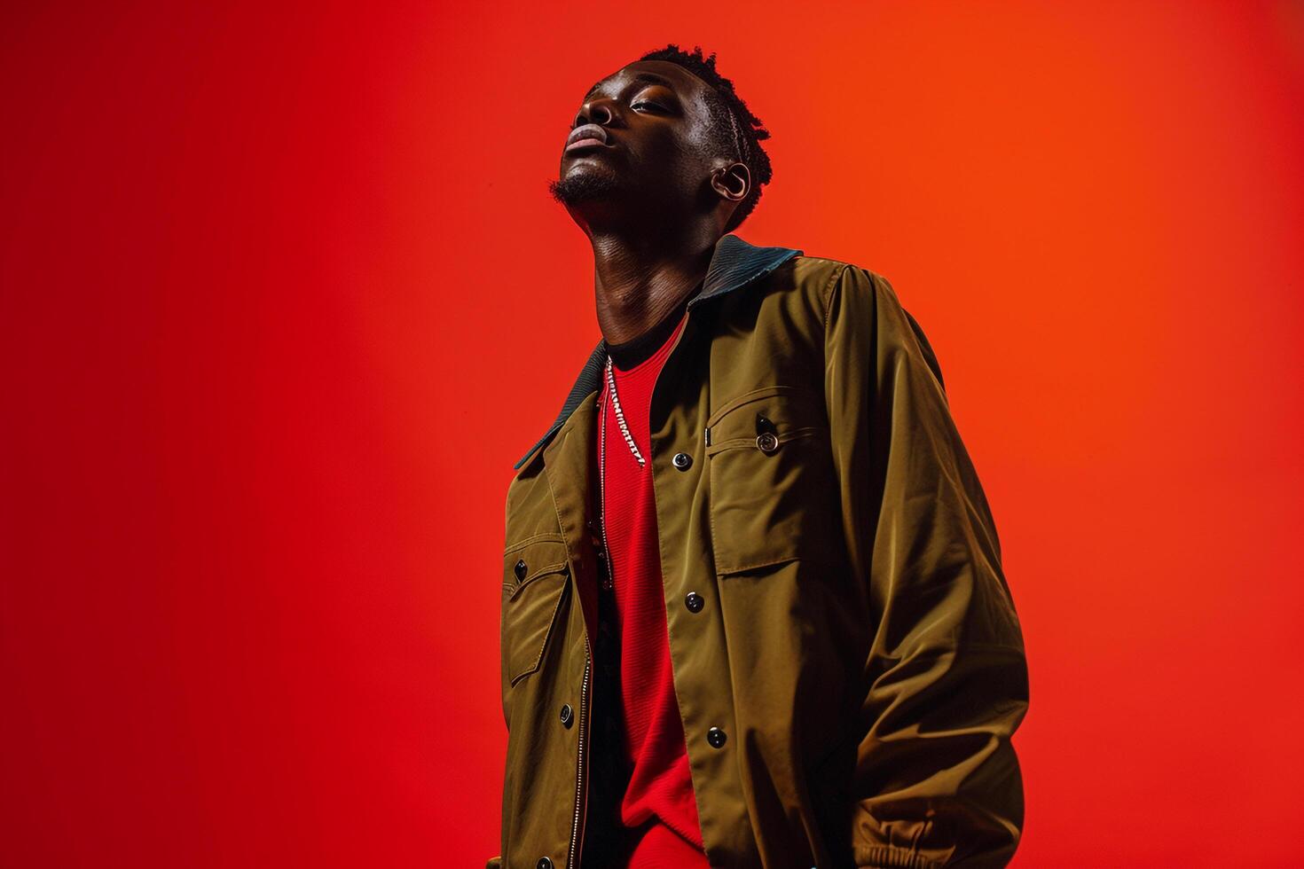Chic male model in a red stateMalet jacket presenting a high fashion portrait and a trendy lifestyle photo