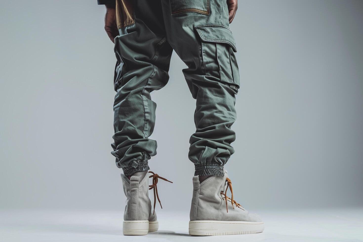 elegant Male Fashion Model in Urban Wear with Cargo pants and Gray Background for Fashionable Look photo