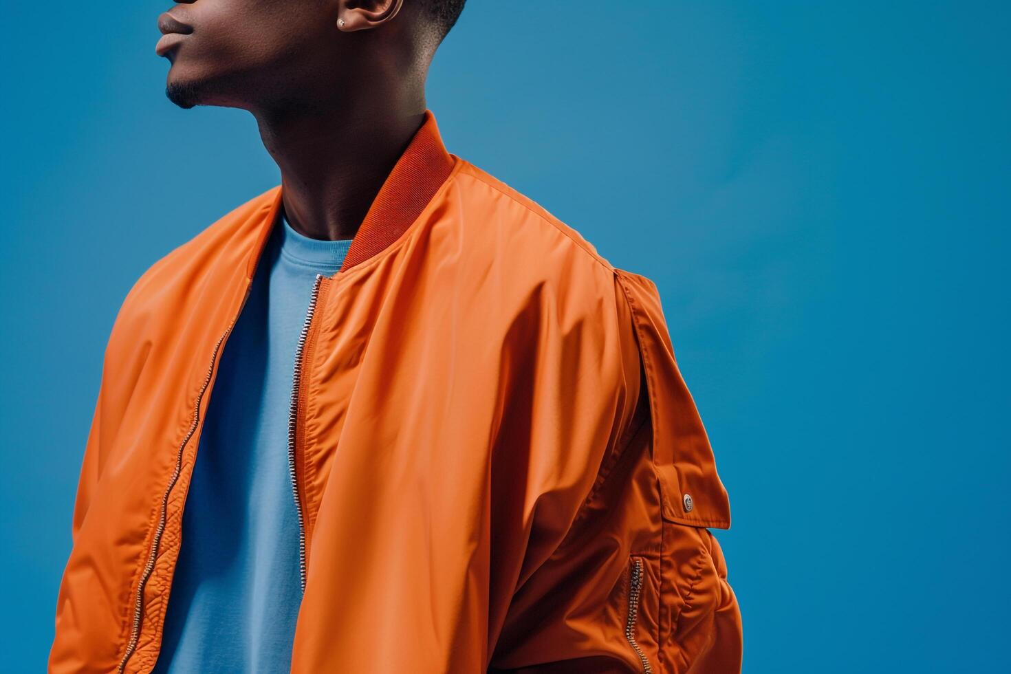 Fashionable Male in Streetwear with Bomber Jacket and Cobalt Blue Background for Stylish Lifestyle photo