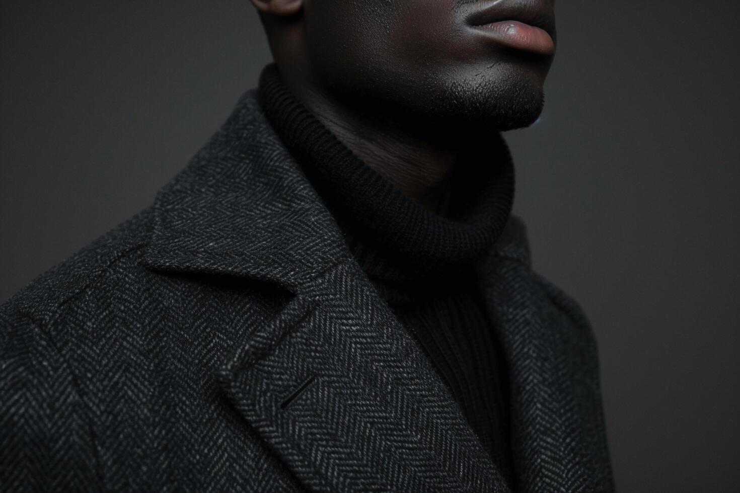 Trendy male model in a tailored jacket with a charcoal background chic portrait highlighting modern and stylish Males outerwear photo