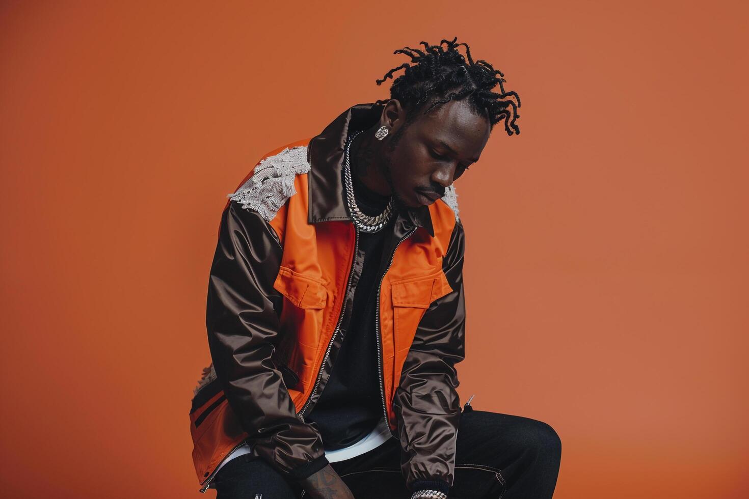 Fashion forward male model in streetwear jacket rust orange background stylish portrait capturing contemporary urban fashion and lifestyle photo