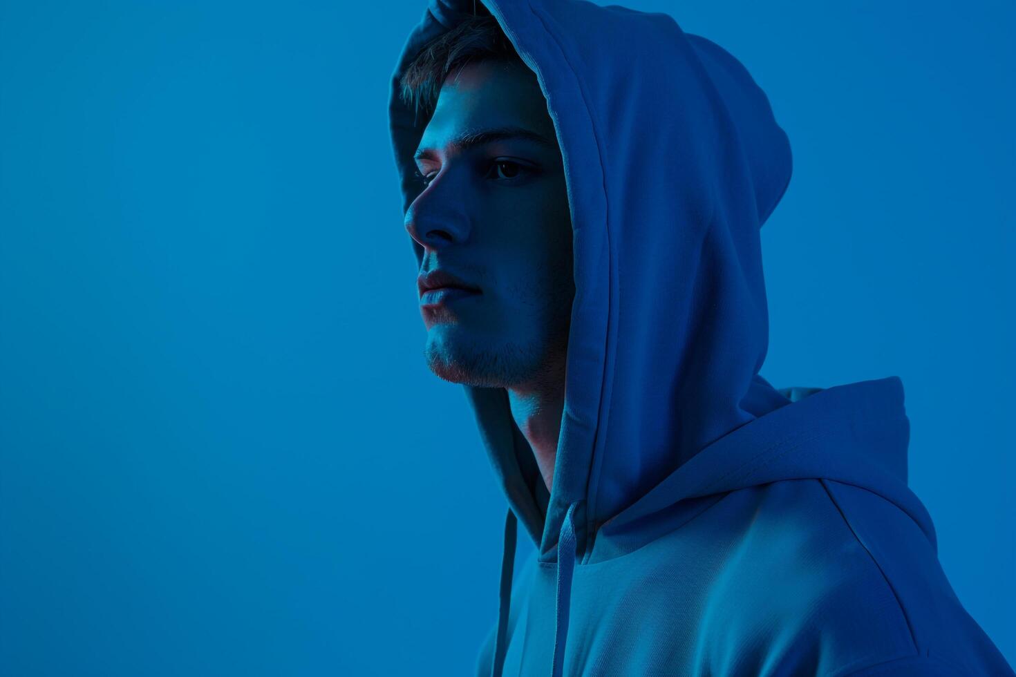 Trendy male fashion model in dress cobalt blue background highlighting a stylish and modern lifestyle with a fashionable portrait photo