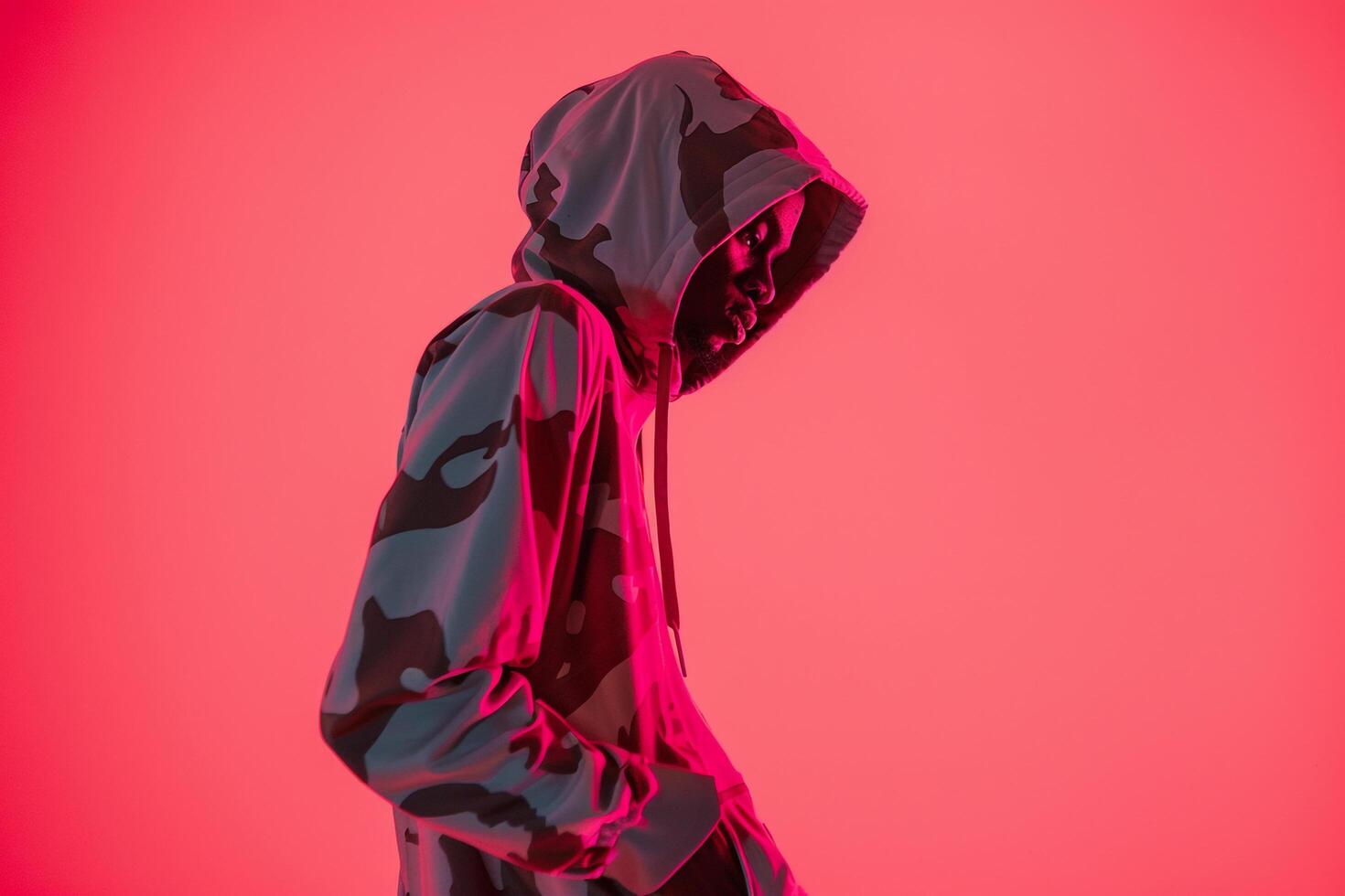Stylish Male Fashion Model in Hoodie with Neon pink Background Featuring Modern and Trendy Lifestyle Fashion Look photo
