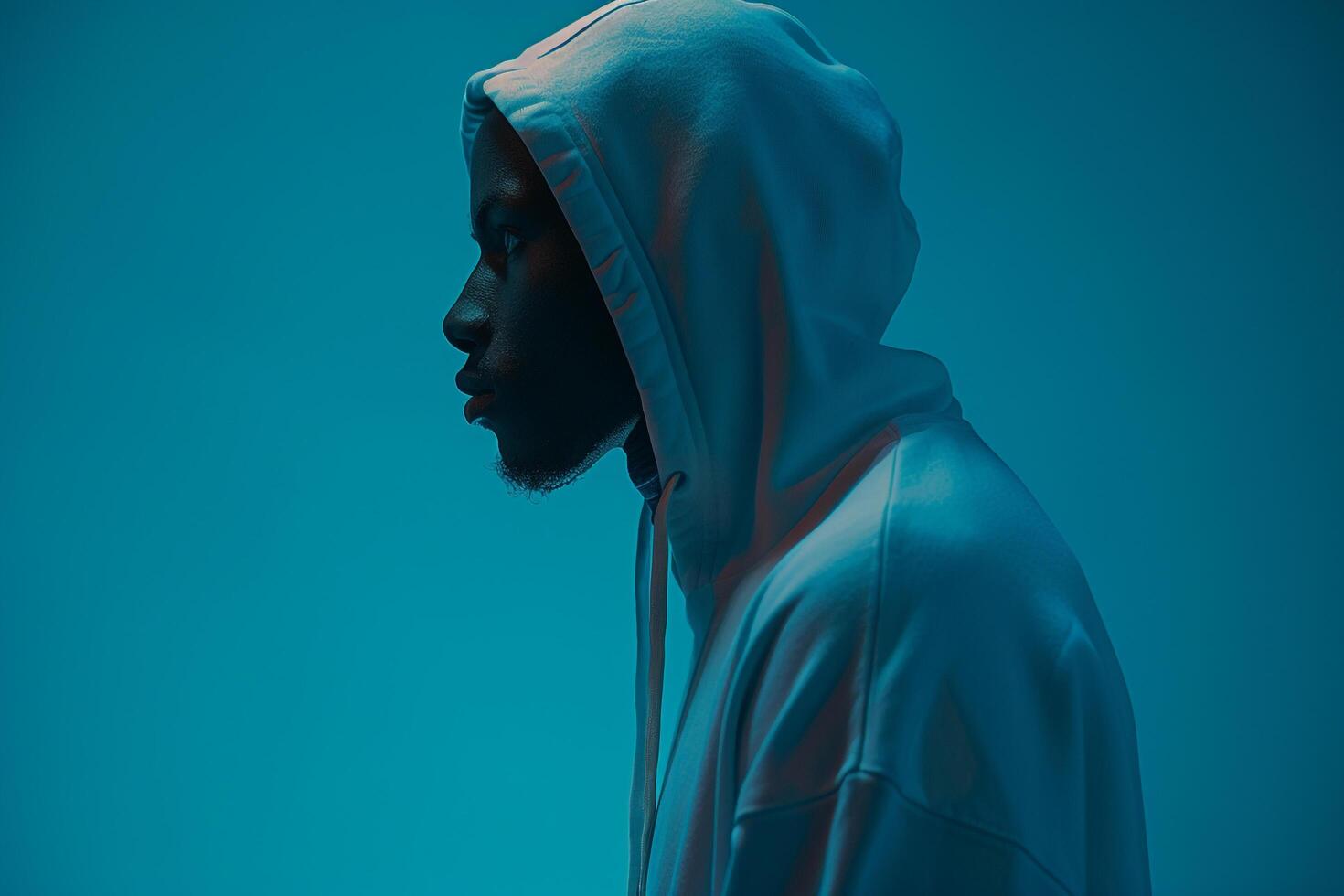 Handsome male model in a hoodie with a bright aqua background showcasing a trendy and contemporary lifestyle with a modern touch in Males fashion photo