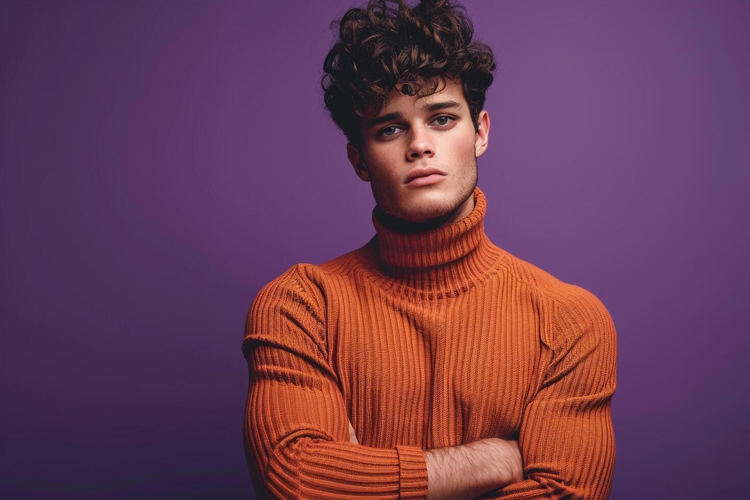 elegant male fashion model in a pullover with a royal purple background showcasing a stylish fashion look and a contemporary lifestyle photo