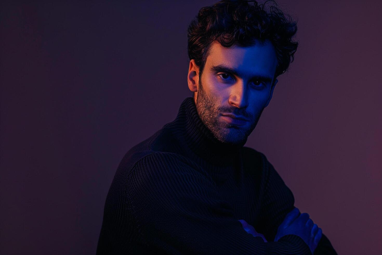 Chic male fashion model in a pullover with a royal purple background showcasing a stylish appearance and a trendy lifestyle photo