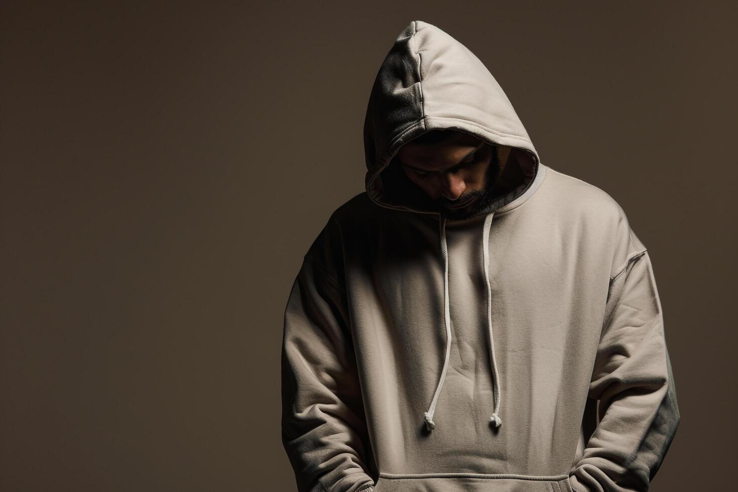 Casual Hoodie Clad Male with Costume Taupe Background Showcasing Relaxed Fashion in a Comfortable Lifestyle portrait photo