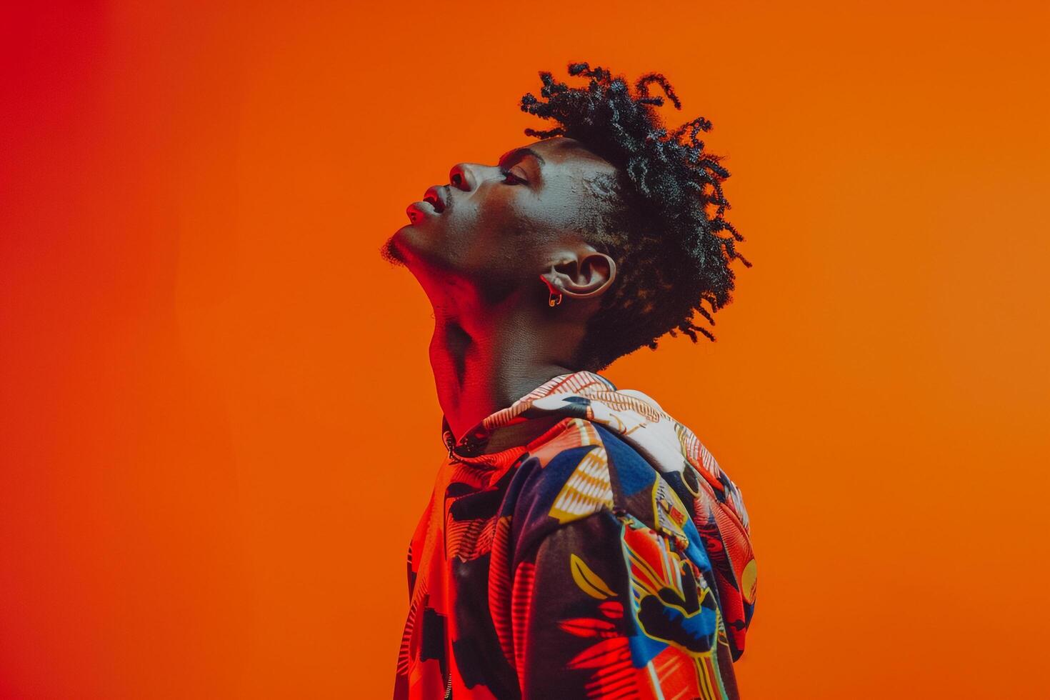 printed Sweatshirt Clad Male with Tangerine Background Focusing on Maleswear Design in a Trendy Lifestyle portrait photo
