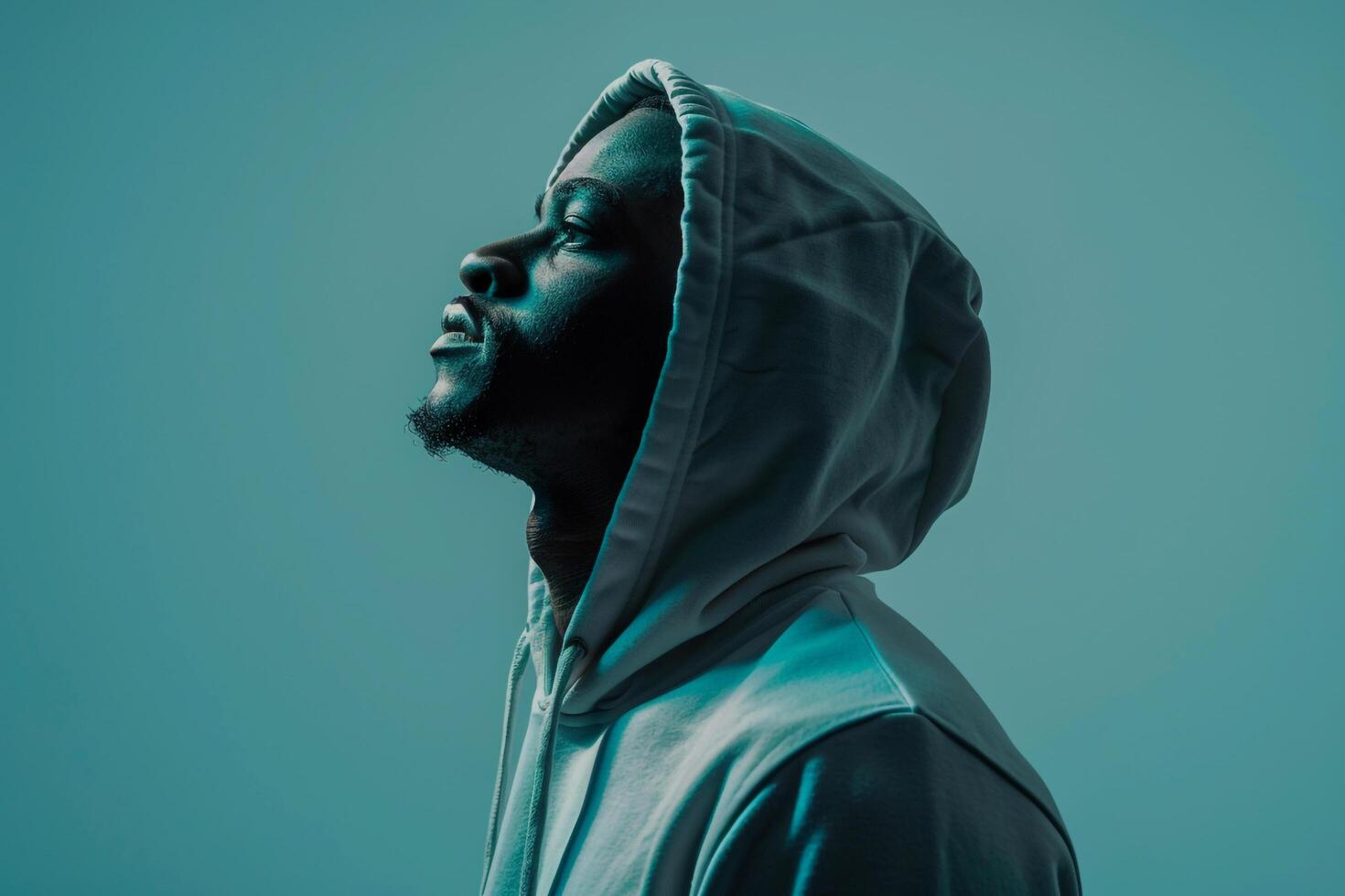 Teal Blue Background with Male in Hoodie  Lifestyle portrait emphasizing Costume Casual Fashion photo