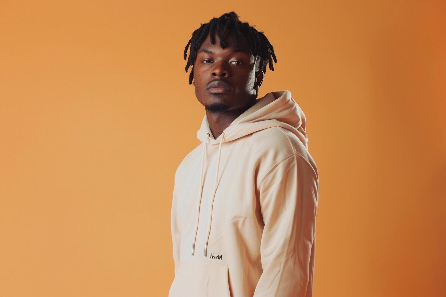 Light peach Background Featuring Male in Hoodie  Lifestyle portrait Highlighting Soft Comfortable Style photo