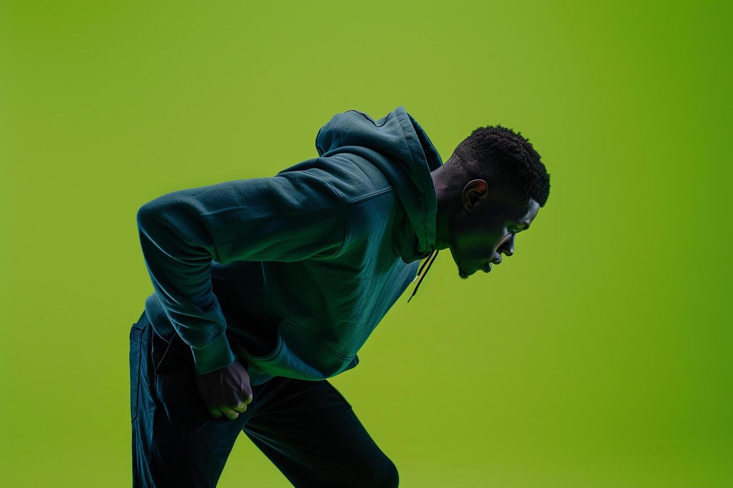 Bright Lime Green Background with Hoodie Clad Male Lifestyle portrait Highlighting Fashion and Trendy Look photo