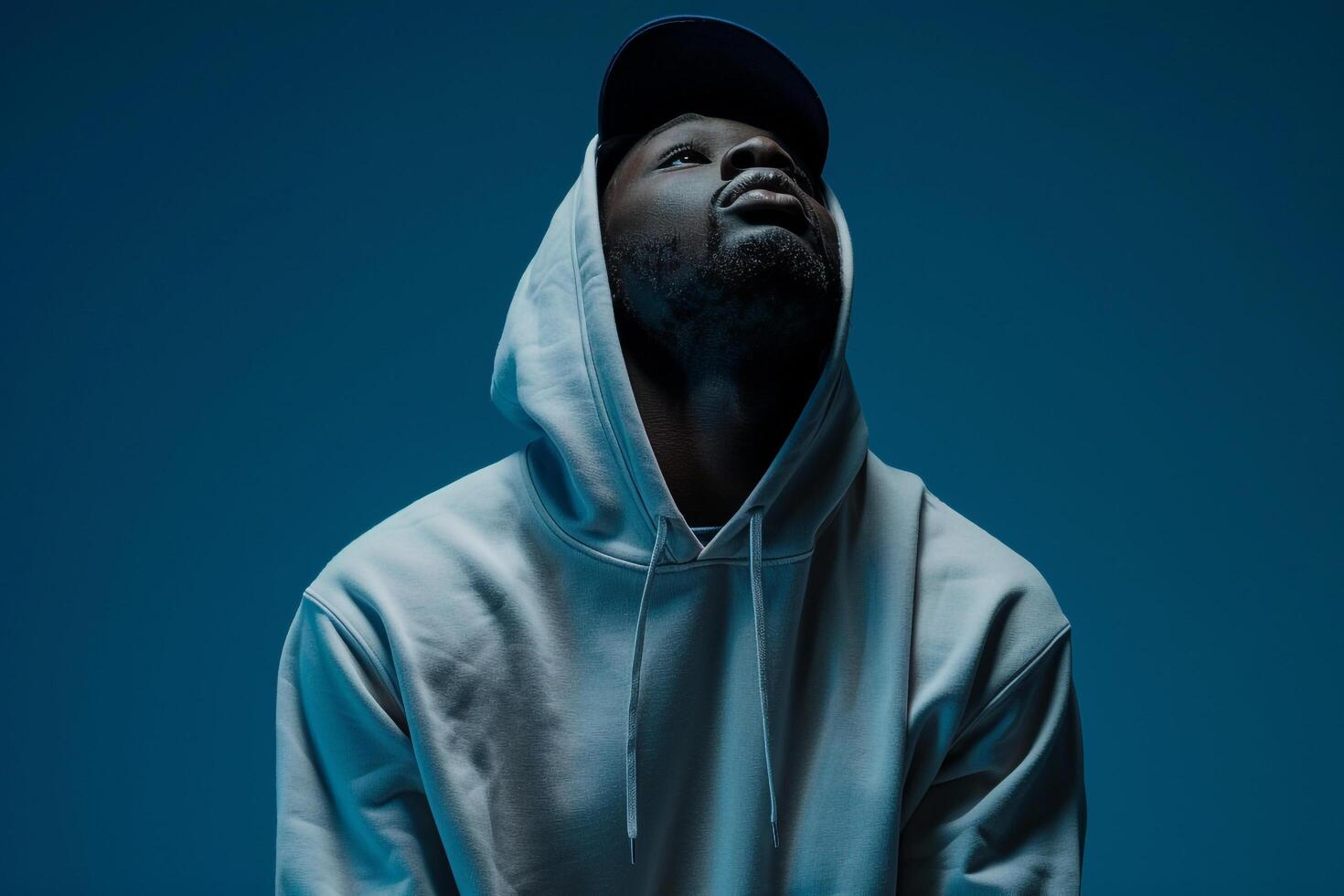 streetwear hoodieposed in a male dress with a deep blue Males backgroundfocusing on lifestyle and fashion portrait style photo