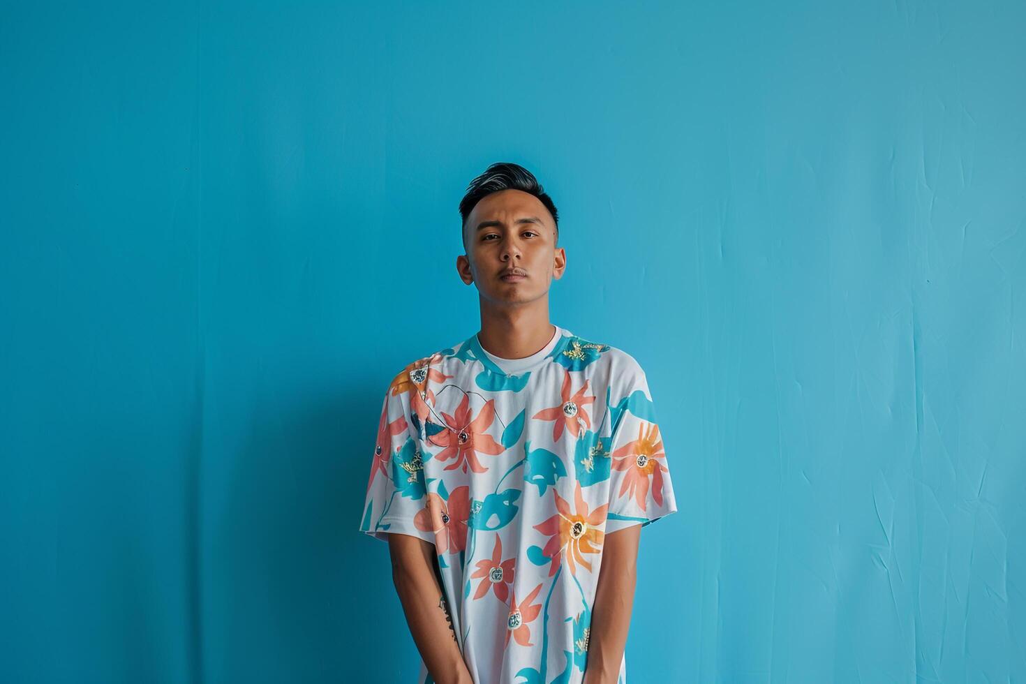 Oversized Graphic Tee Clad Male with Sky Blue Background  Lifestyle portrait Featuring Trendy Apparel and Relaxed Style photo