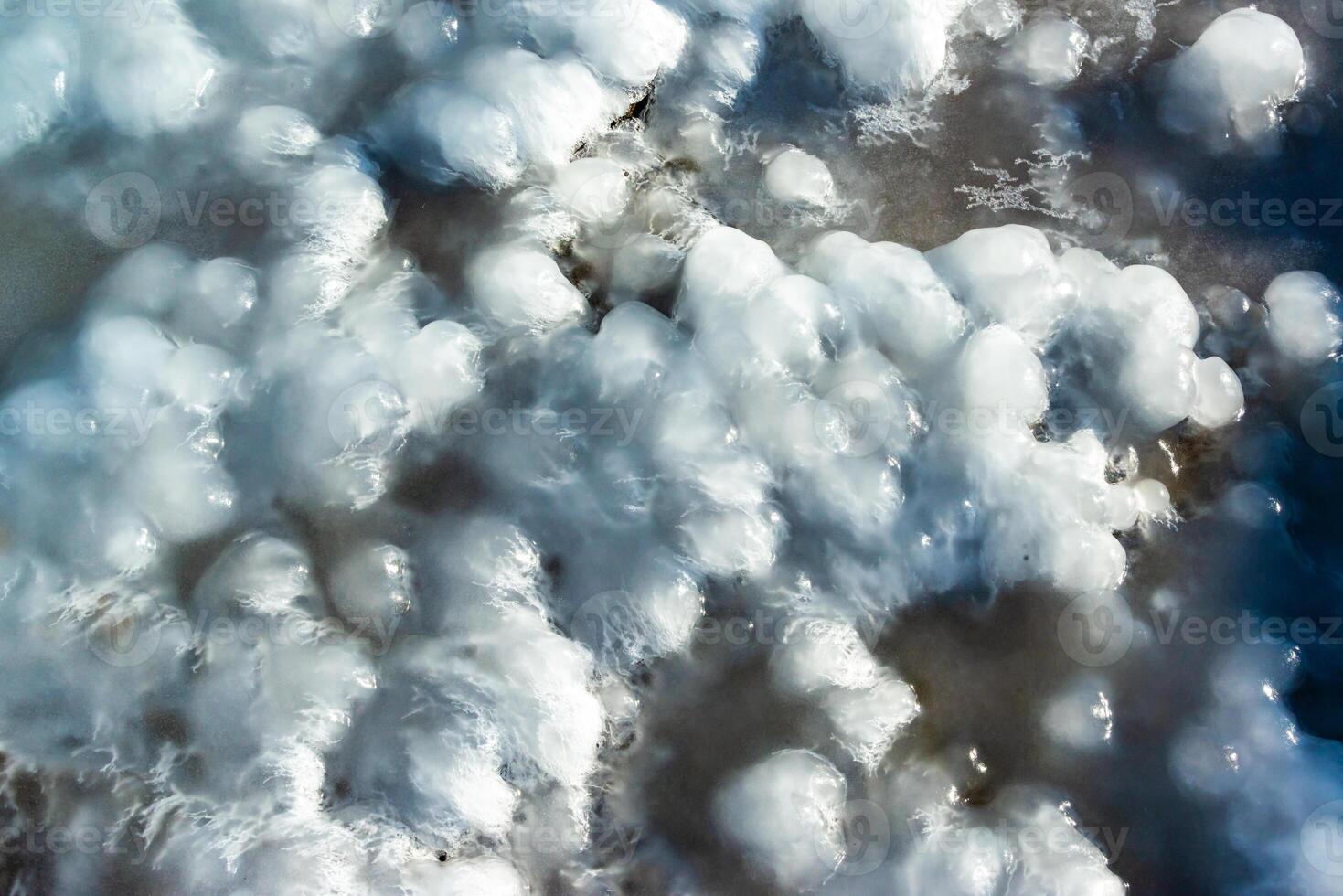 Smooth blocks of melting ice glisten in the sun, ice near the Black Sea, Odessa photo
