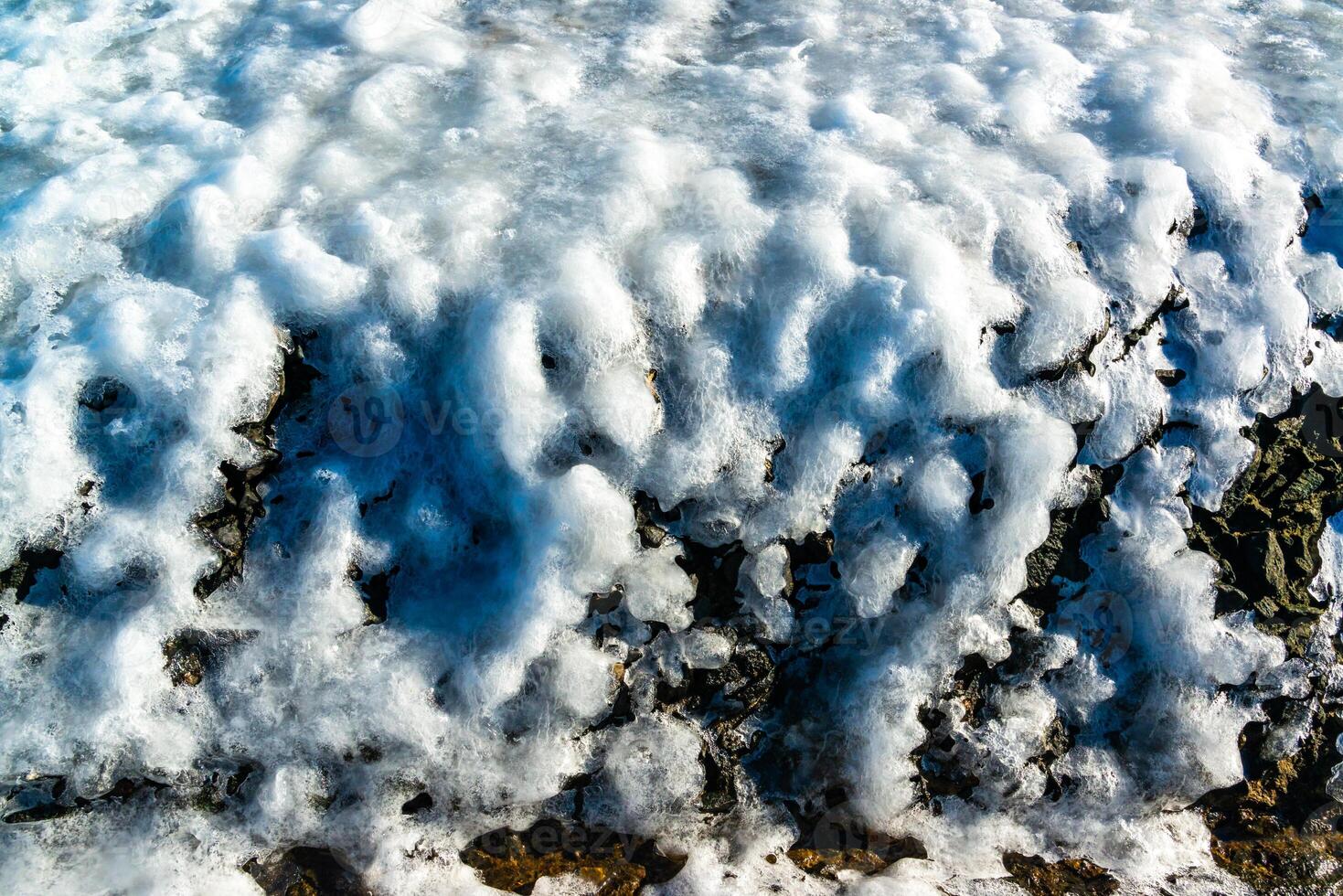Smooth blocks of melting ice glisten in the sun, ice near the Black Sea, Odessa photo