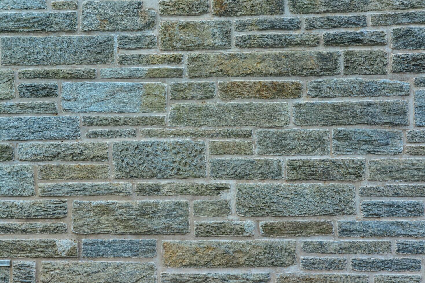 Antique brick wall made of natural stone. photo