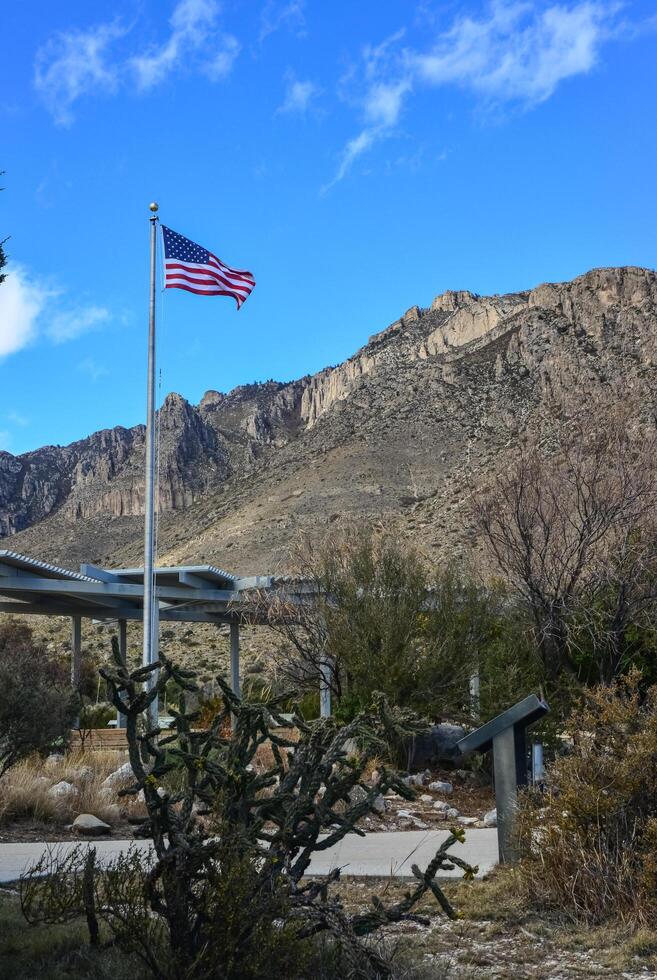 NEW MEXICO, USA - NOVEMBER 22, 2019 American flag against a blue sky in the territory of a visit center in a park in New Mexico photo