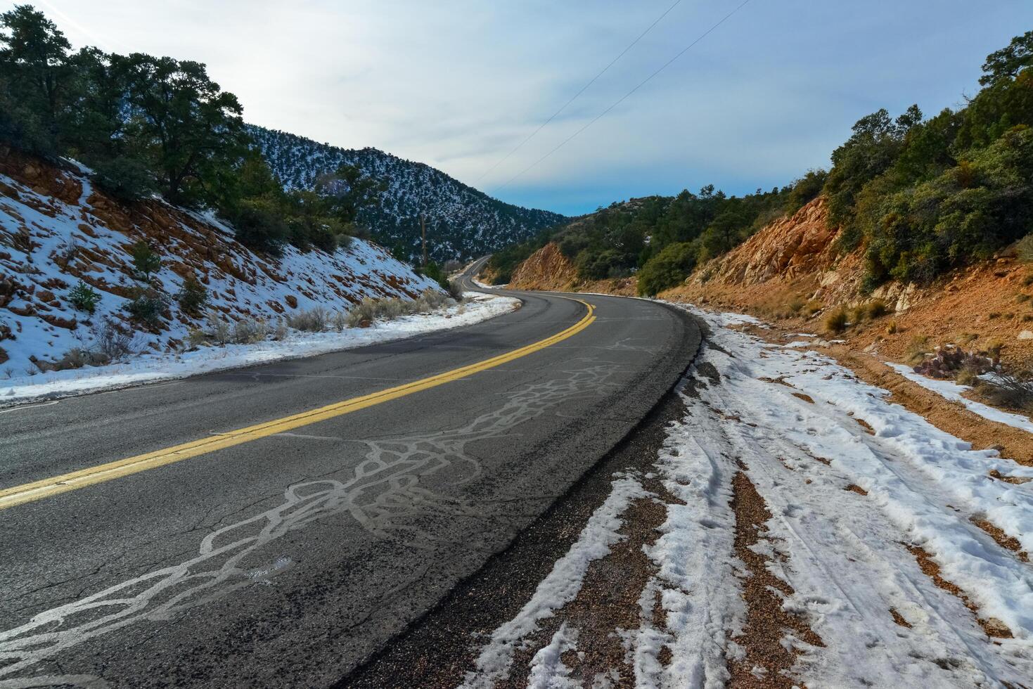 Snowy mountains and snow along the road on a mountain pass in the Death Valley area photo