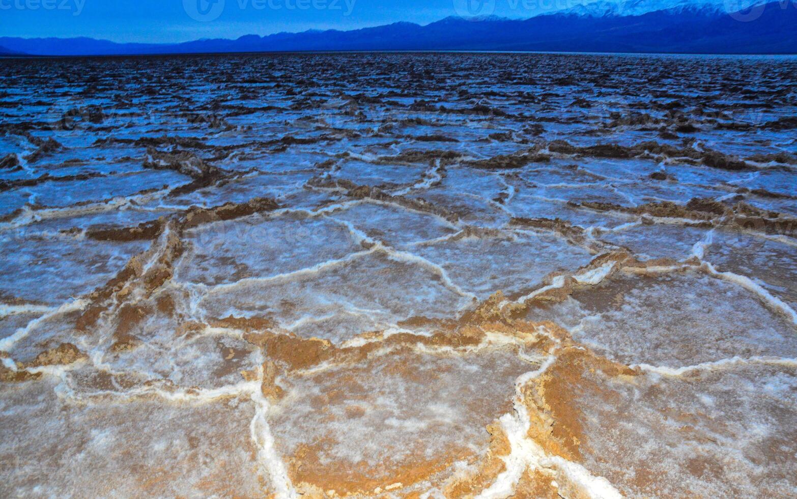 Death Valley National Park, Salt with clay, California. Smooth salt valley with cracked and swollen salt, dead salt landscape photo