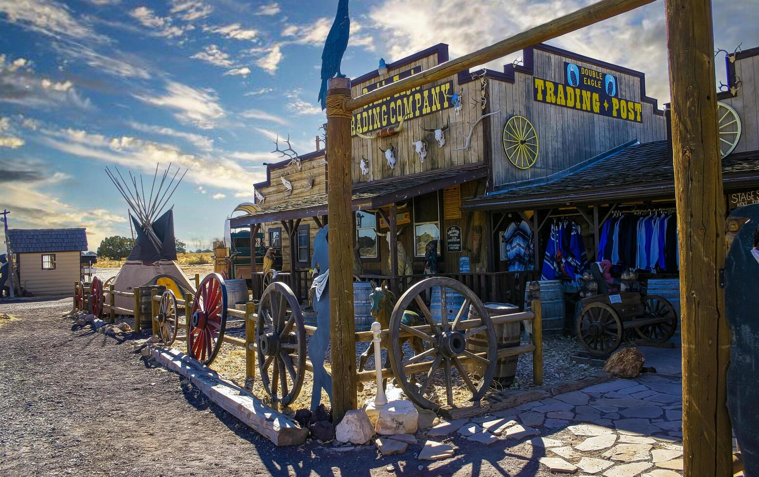 Arizona, USA - November 27, 2009 Rustic wooden saloon flanked by a traditional teepee and vintage barrels in a western setting photo