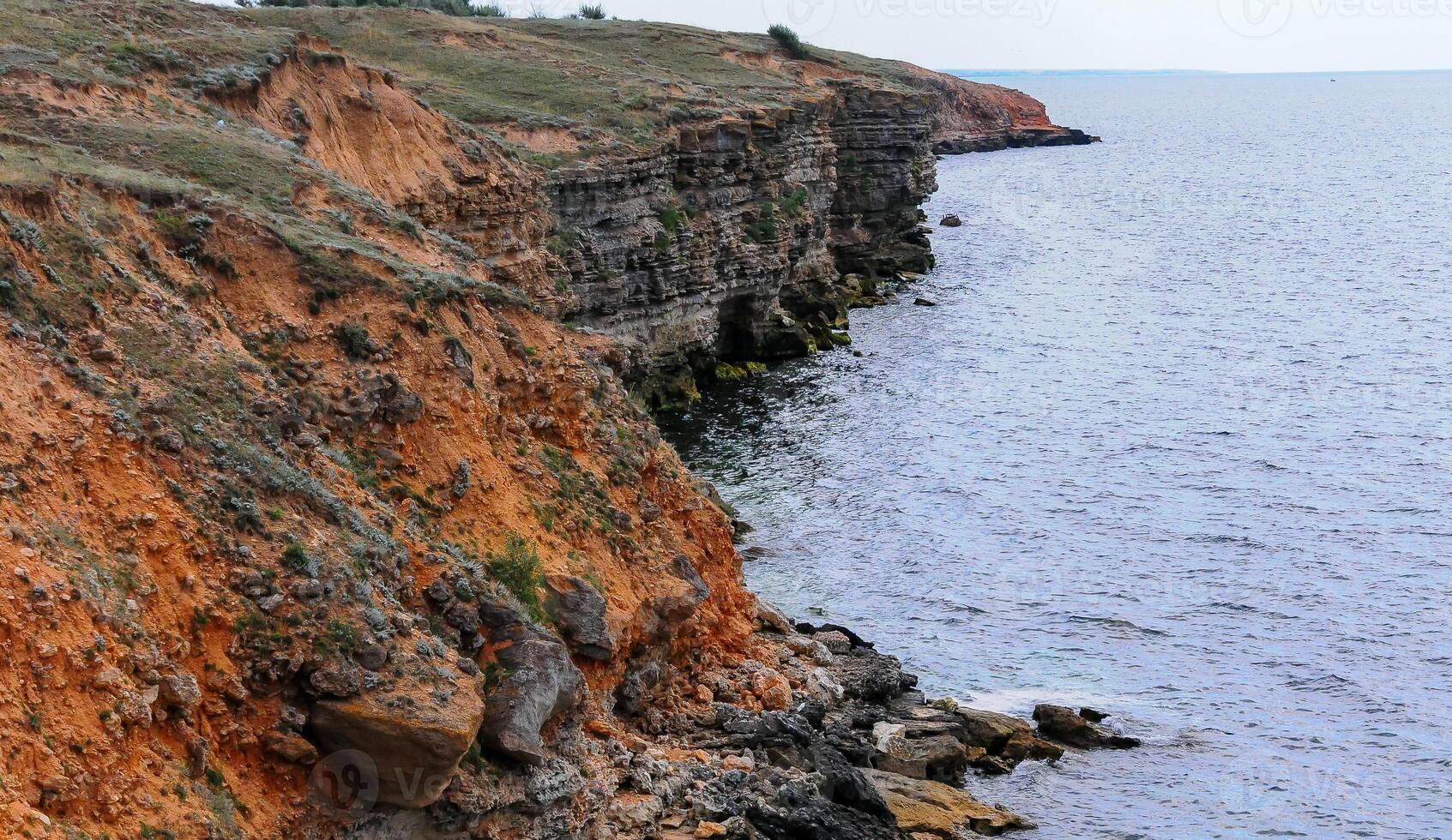 An impregnable precipitous rocky shore in the eastern Crimea photo