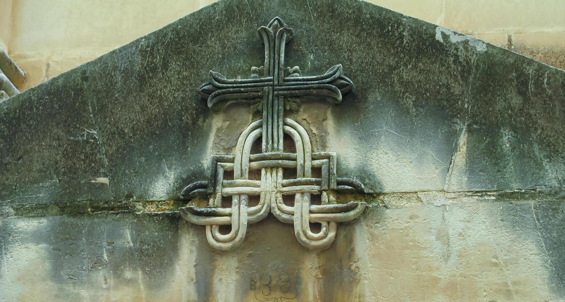 GOZO, MALTA - SEPTEMBER 14, 2012 Maltese cross with decor on an old building in Valletta, Malta photo