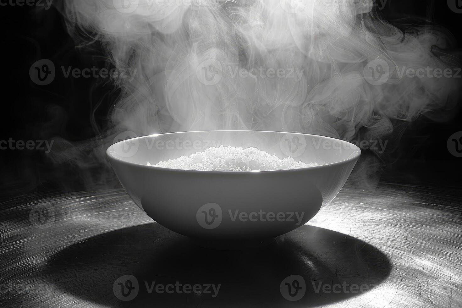 White Bowl Filled with Steaming Substance on a Metallic Surface photo