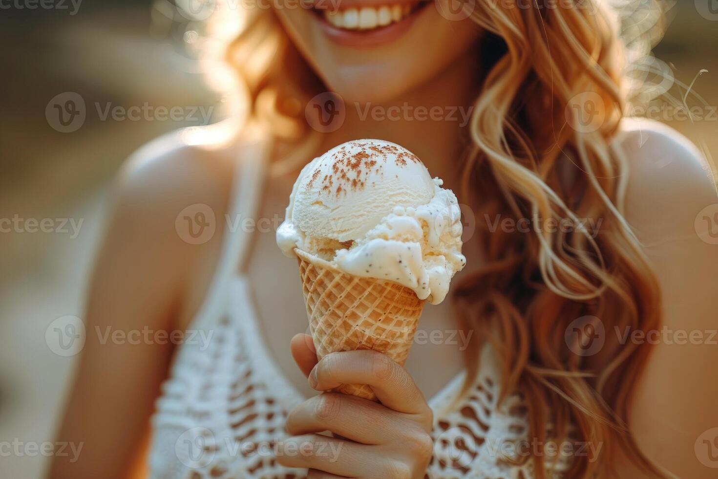 Close-up of a Woman Holding an Ice Cream Cone with a Smile photo