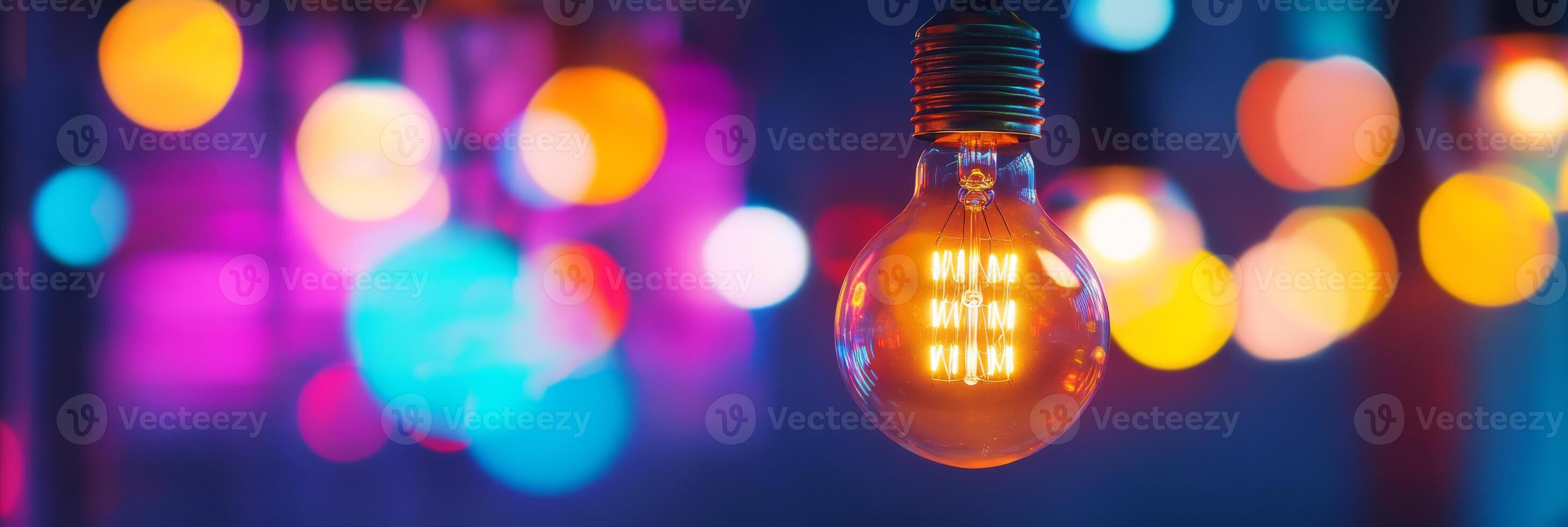 This beautiful closeup image of a glowing Edison bulb, surrounded by an array of vibrant, soft bokeh lights, creates a warm and inviting atmosphere that truly captivates everyone who sees it photo