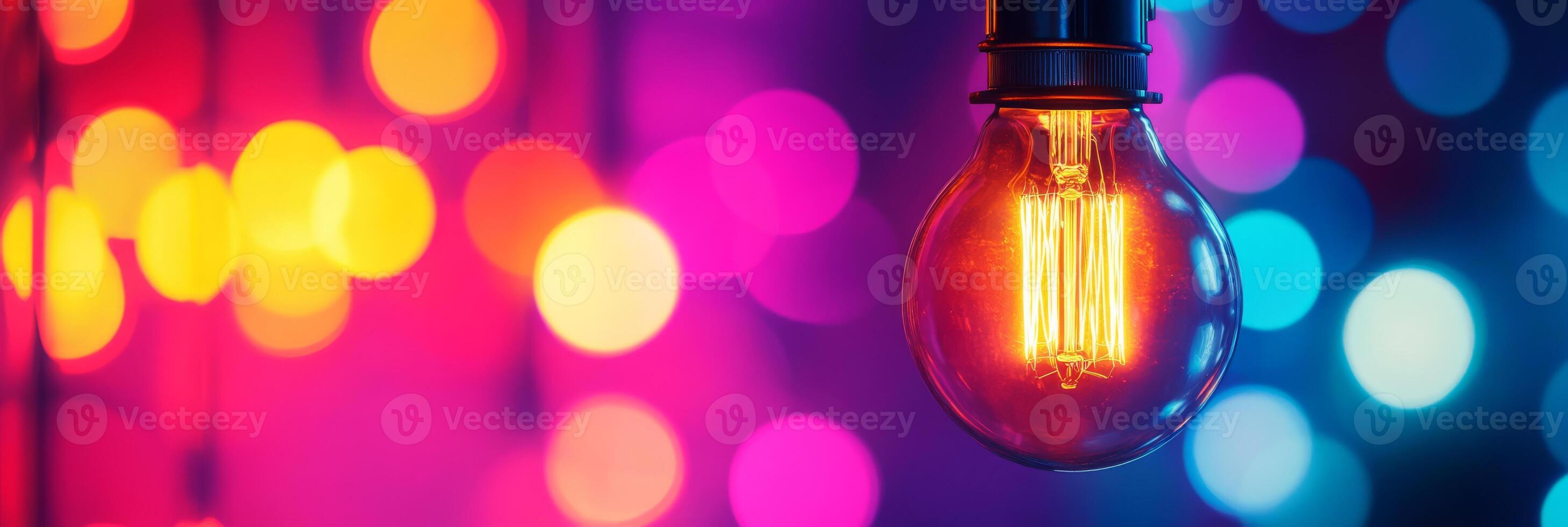 This image showcases a stunning closeup of an illuminated Edison bulb against a colorful bokeh background, highlighting a mesmerizing play of colors and light that captivates viewers photo