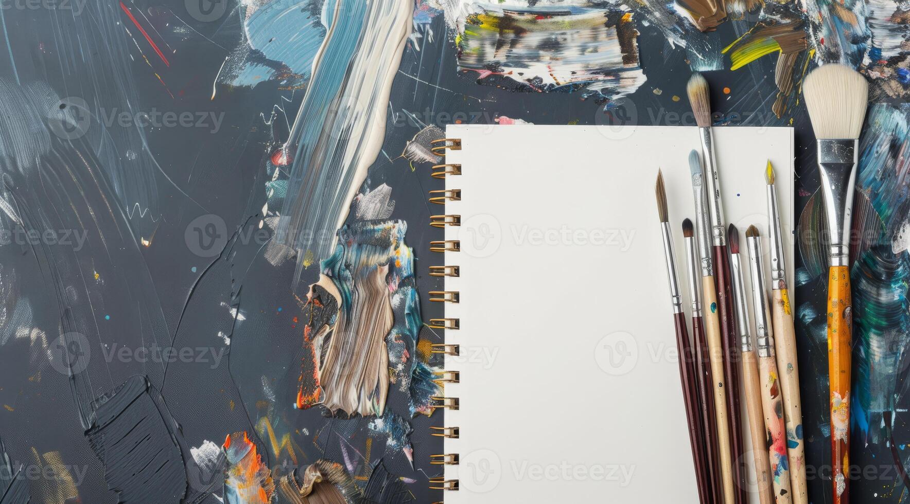 This art supplies mockup features colorful paint brushes and a blank sketchbook arranged on a vibrant palette background, designed to inspire creativity and artistic expression in viewers photo
