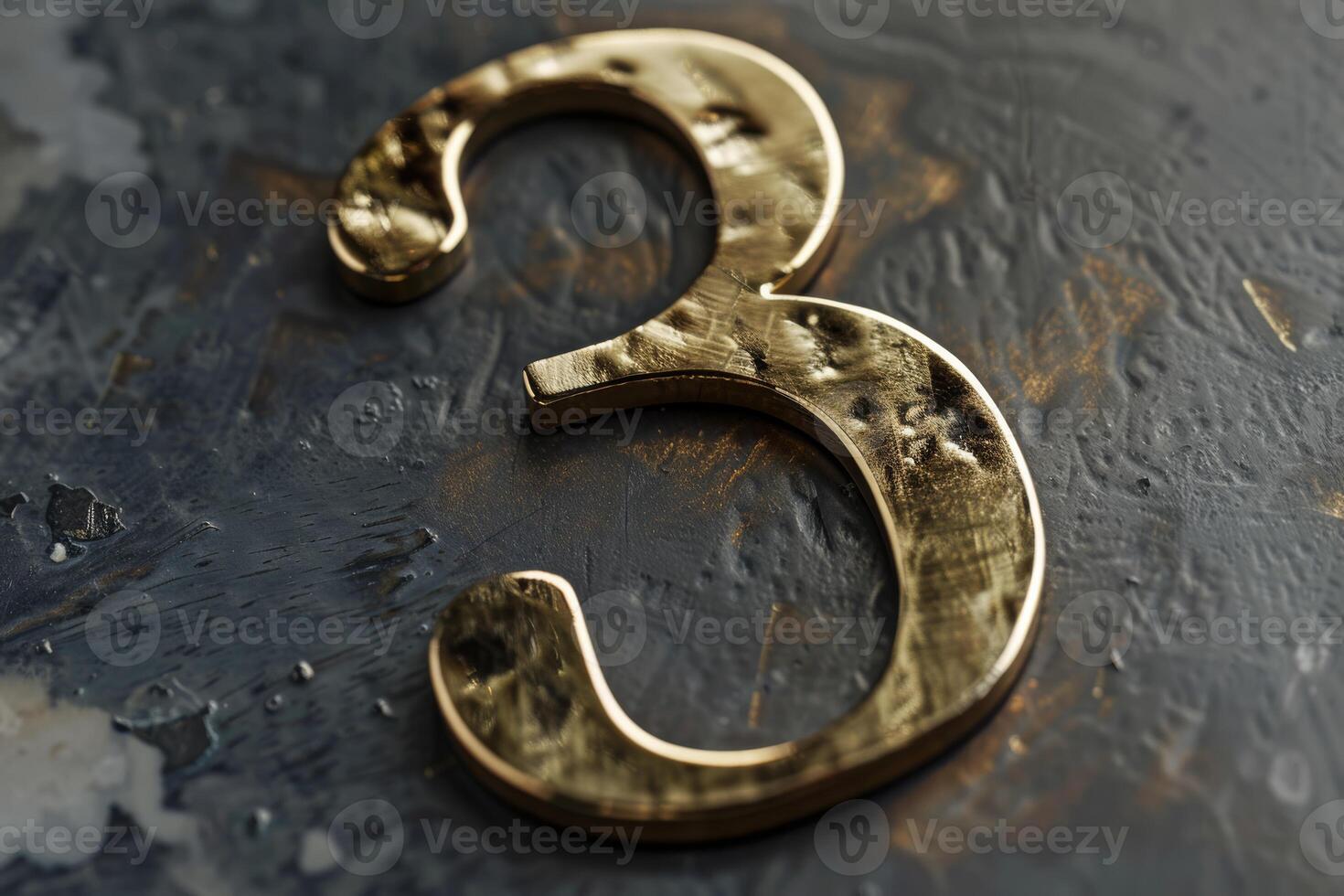 A beautifully crafted, shiny gold number 3 is elegantly set against a dark, textured and artistic surface photo
