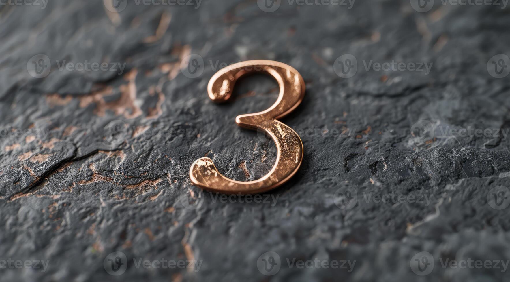 A closeup view capturing a decorative copper number three beautifully placed upon a textured stone surface photo