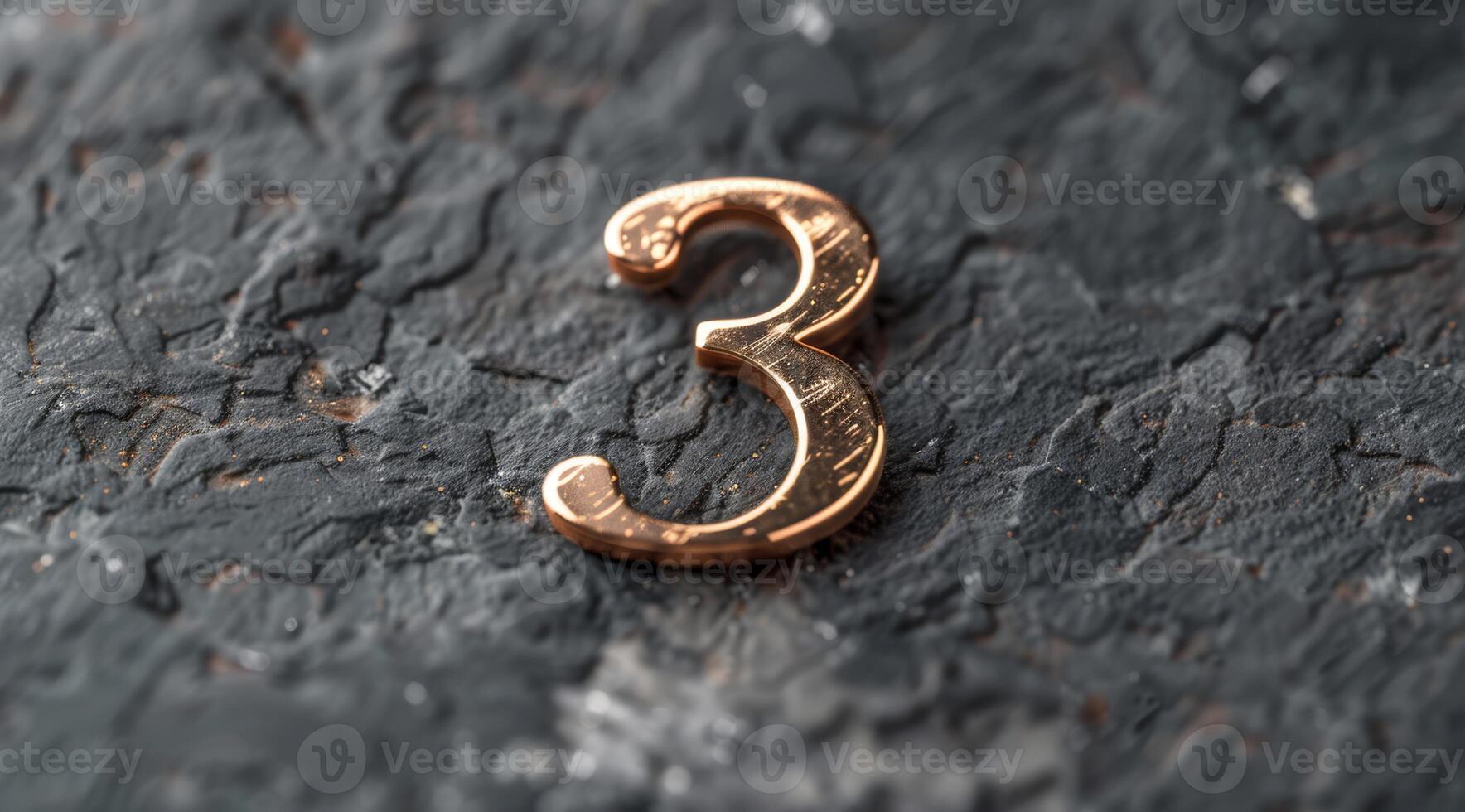 A distinctive metallic number three set on a textured dark surface, perfect for various creative projects photo