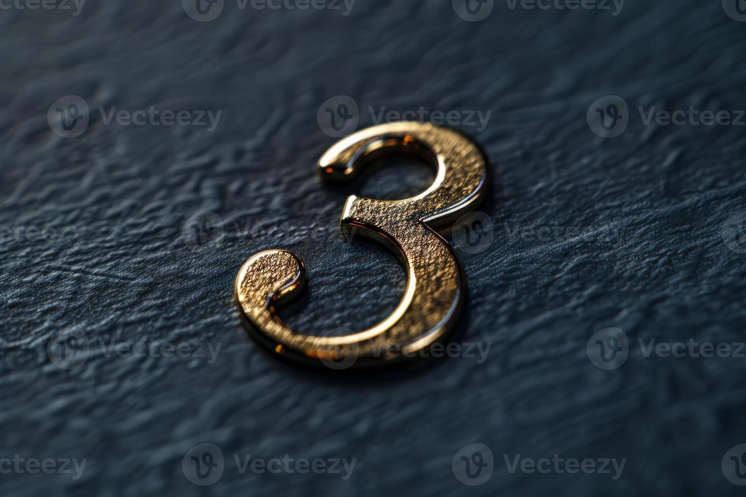 A closeup view of a vintagestyle metallic number three displayed on a textured dark surface background photo