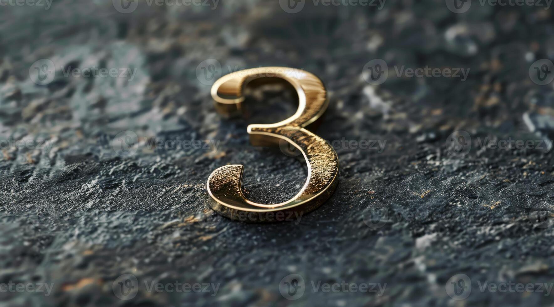 An elegant and stylish golden numeral three is beautifully showcased on a textured stone background surface photo