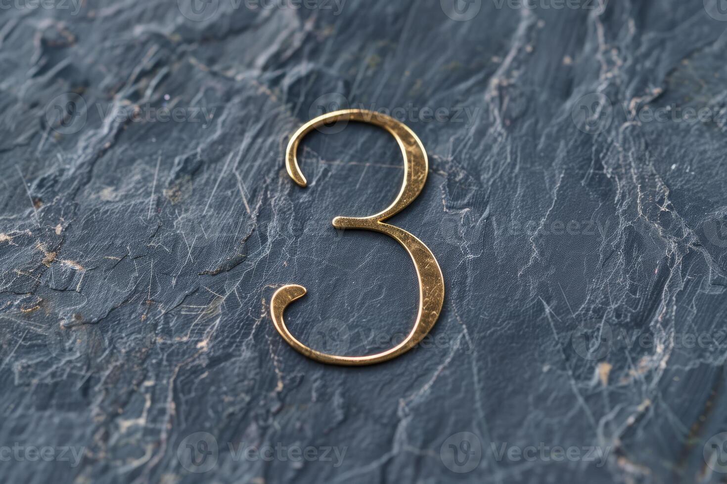 An exceptionally stylish representation of the number 3 artfully designed on a beautifully textured dark slate surface photo