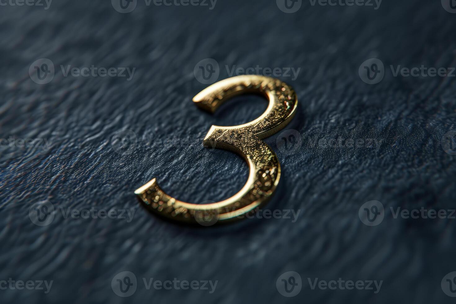 A beautifully crafted golden number three is gracefully resting on a richly textured dark background for contrast photo
