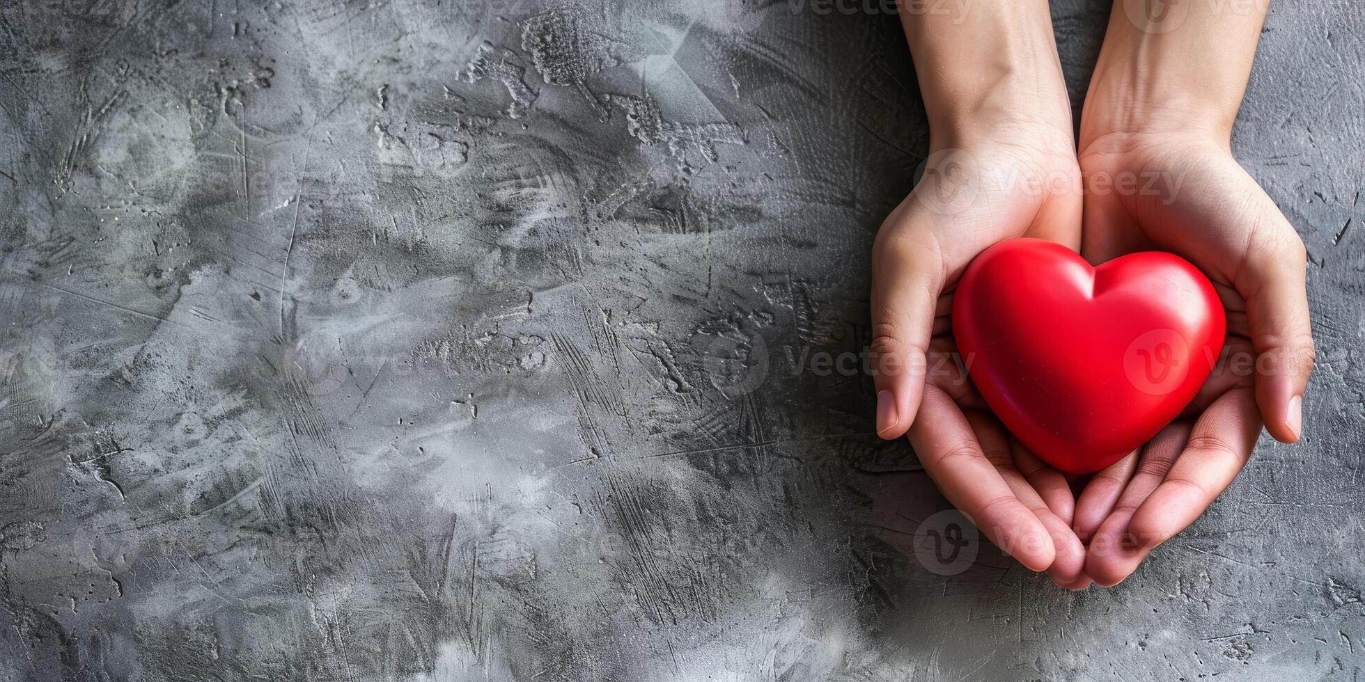 A heartfelt image of two hands gently cradling a vibrant red heart, beautifully symbolizing deep love and care photo