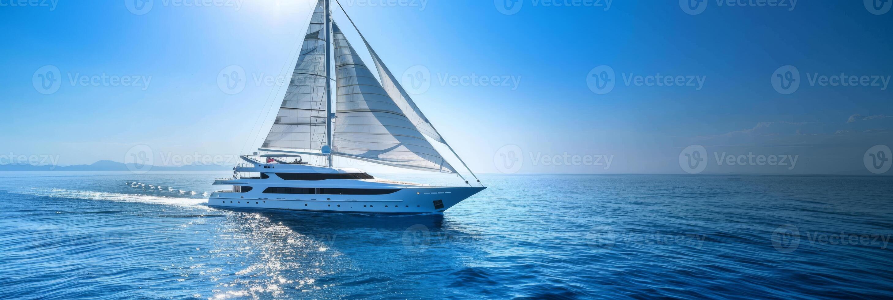 An elegant yacht sails on calm blue waters beneath a clear sky, epitomizing luxury and total relaxation photo