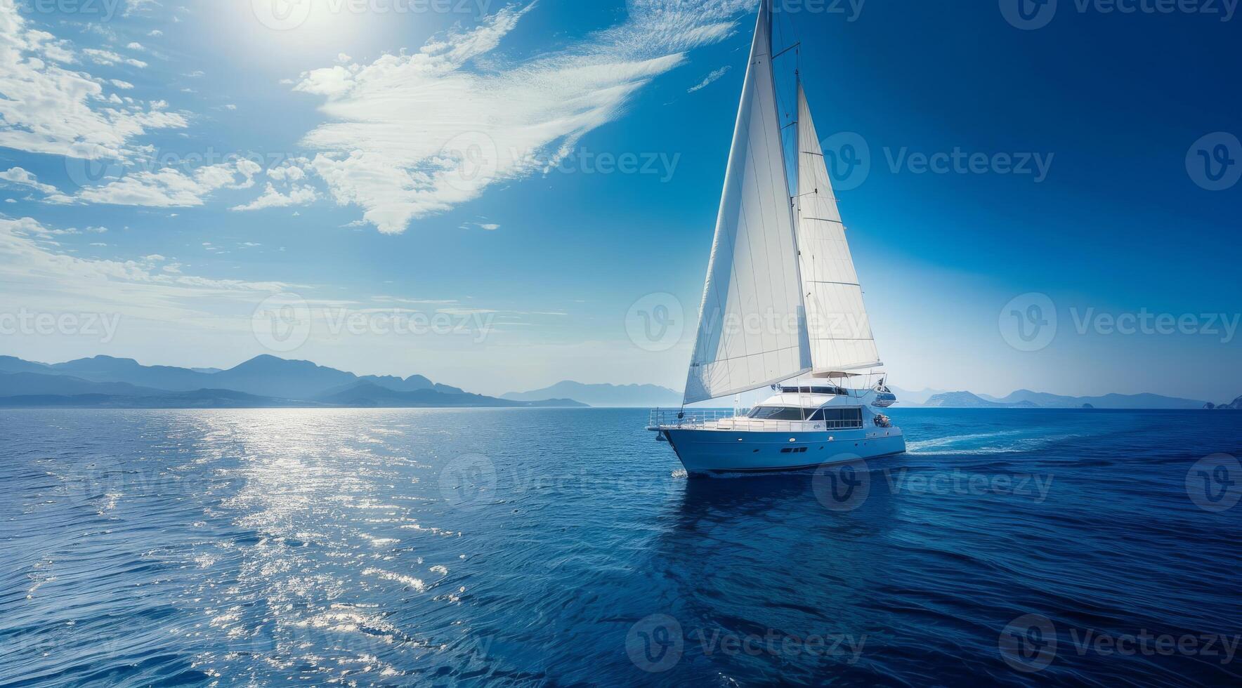 A stunningly beautiful sailing yacht gracefully gliding across the tranquil ocean waters beneath a bright sunny sky photo