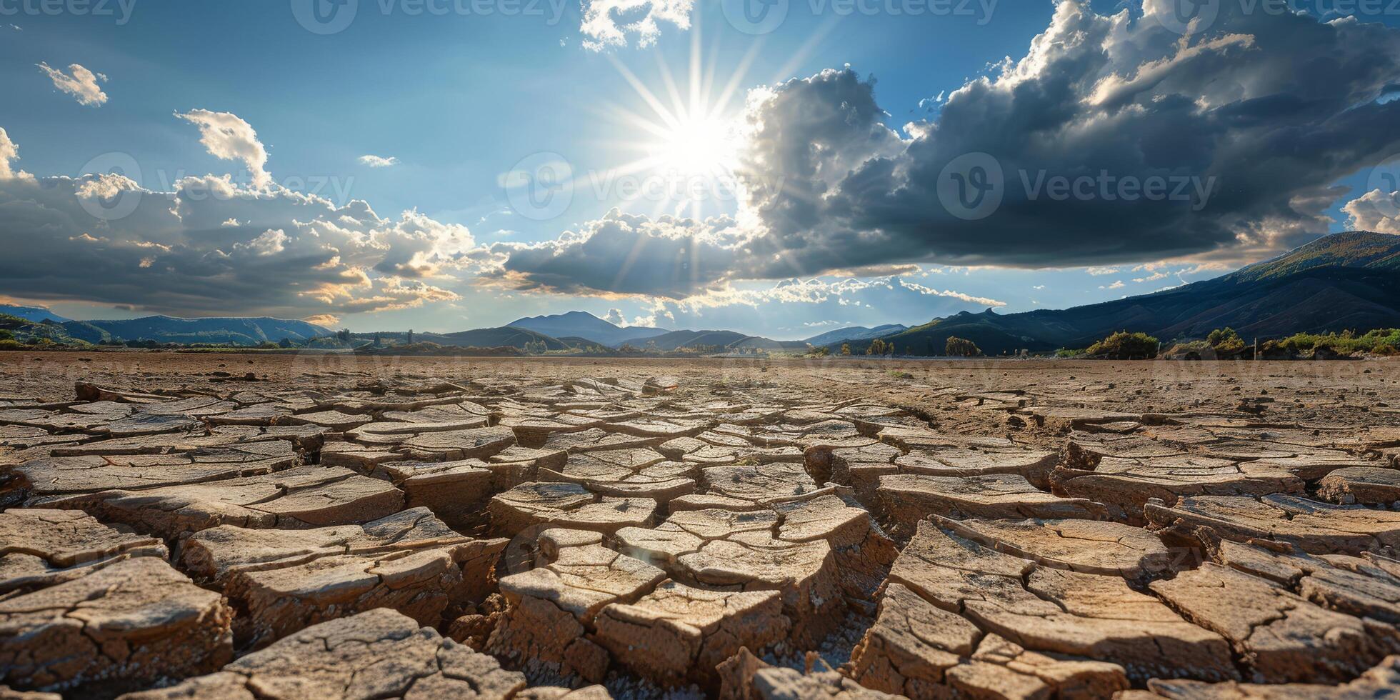 A vivid image illustrates the severe impact of prolonged drought with cracked earth under a bright sun, highlighting the significant challenges of climate change we must all confront photo