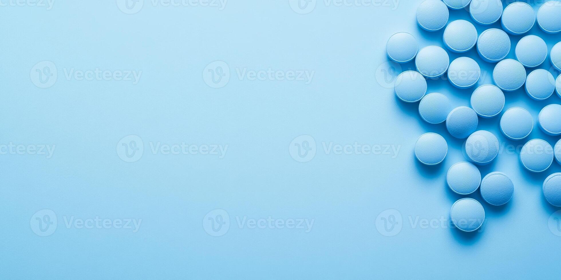 This image prominently features a carefully arranged collection of blue pills set against a soft blue background, effectively conveying various themes of health, healing, and overall wellness in life photo