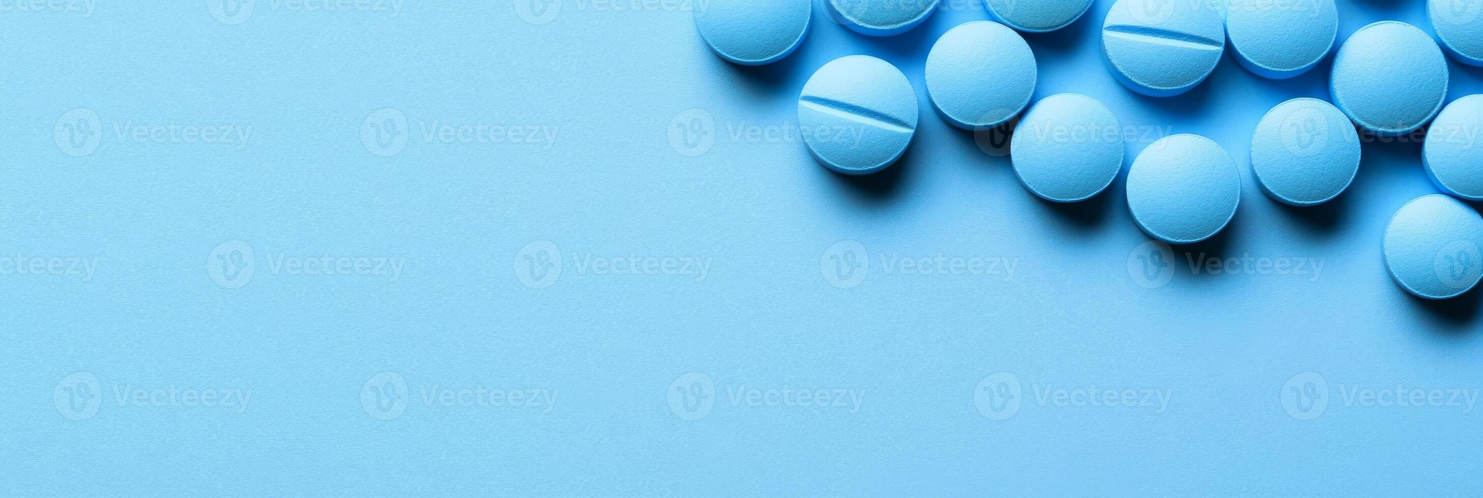 This visually appealing image features a neatly organized collection of vibrant blue pills on a soft blue surface, perfect for topics related to healthcare or the pharmaceutical industry photo