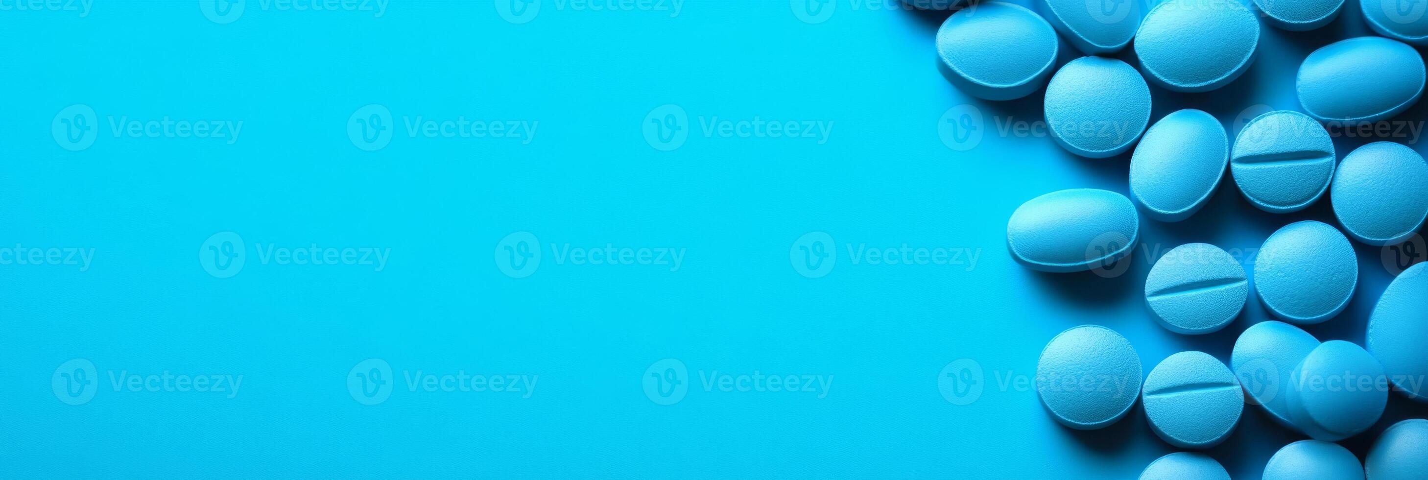 A cluster of blue pills beautifully arranged against a vibrant, eyecatching background, providing ample space for additional text or extra information that may be needed or desired photo