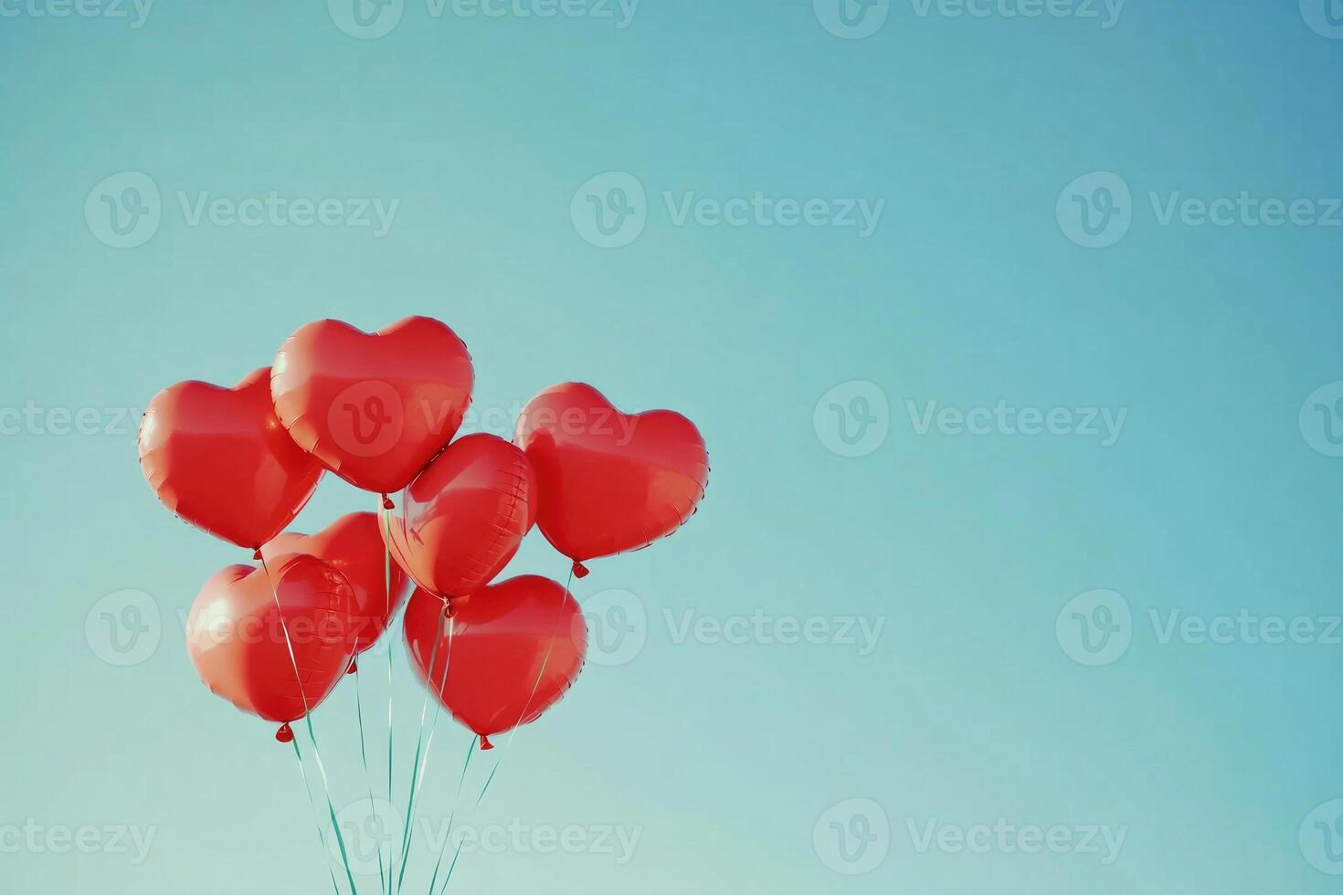 Heart-shaped balloons against a clear sky with text space. photo