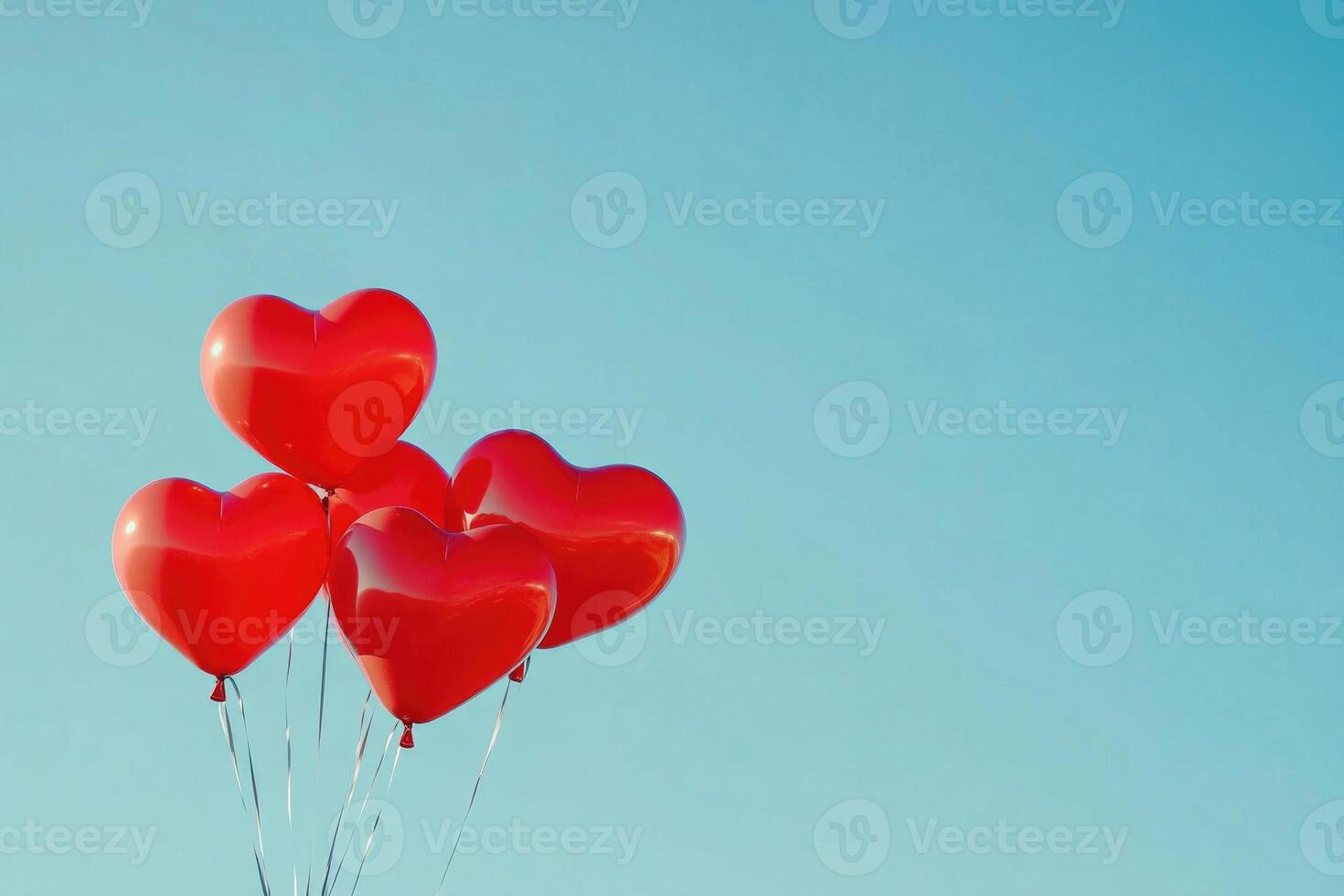 Heart-shaped balloons against a clear sky with text space. photo