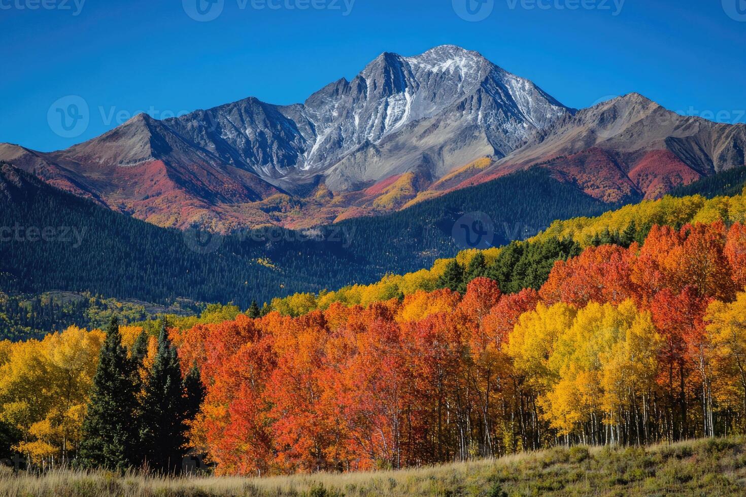 A breathtaking mountain range adorned with autumn colors. photo