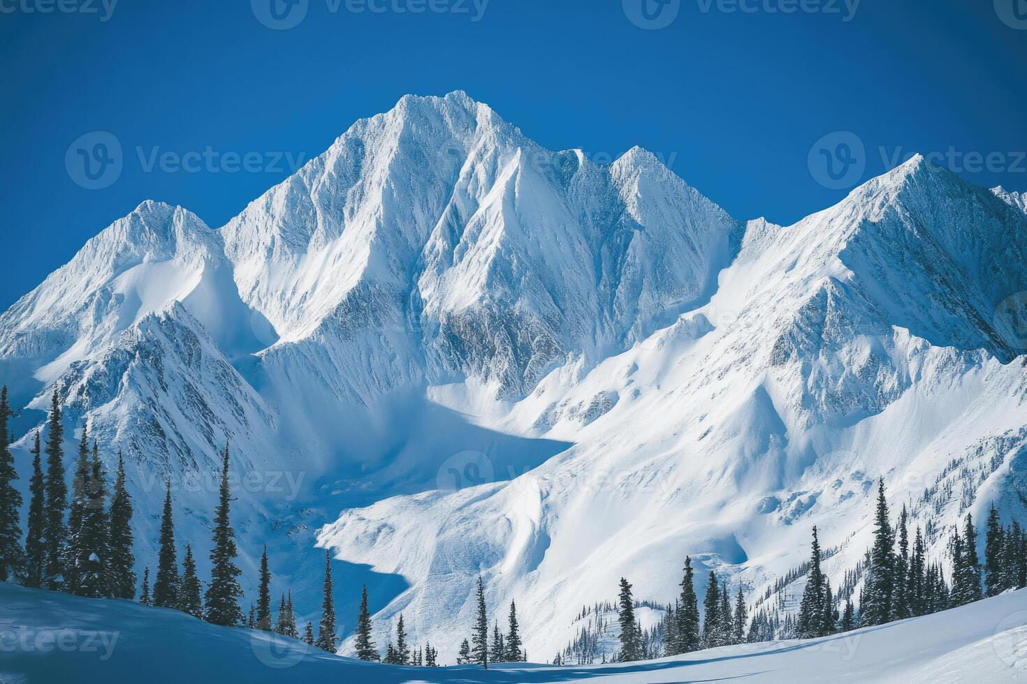 Majestic mountains covered in snow under a clear sky. photo